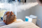 Beauty treatment of face with ozone facial steamer in beauty center.